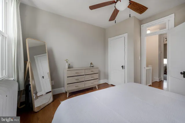 a bedroom with a bed and a ceiling fan