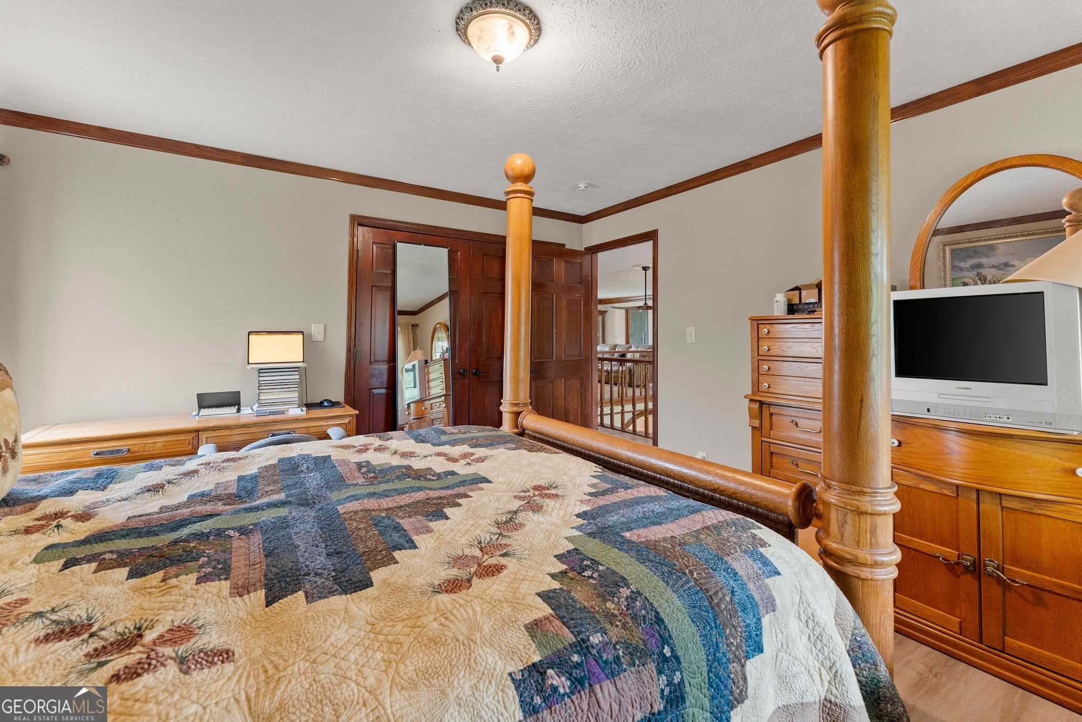 7215 Kelly Bridge Road Dawsonville, GA 30534 - Photo 36 of 87 a bedroom with a bed and a flat tv screen on dresser