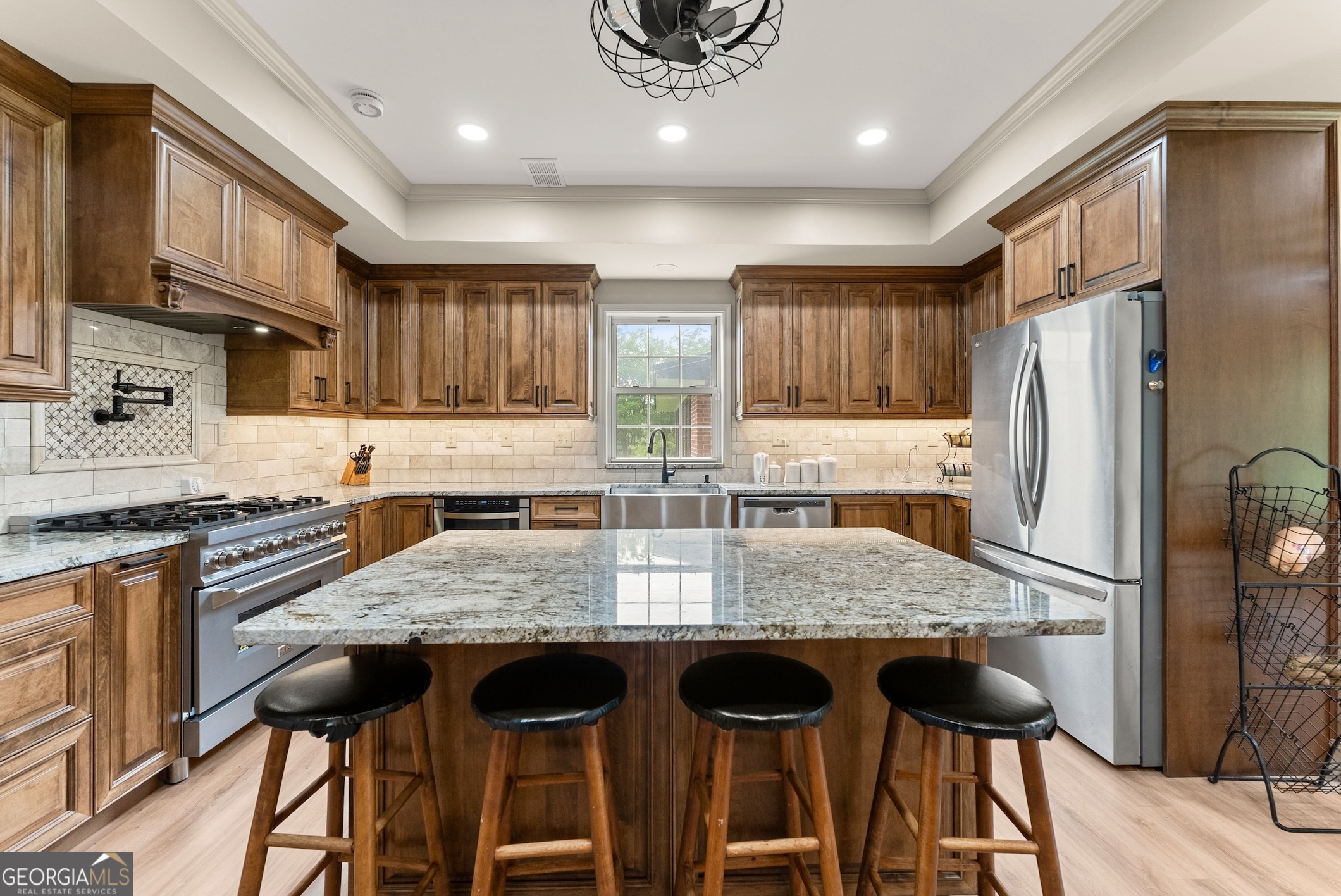 7215 Kelly Bridge Road Dawsonville, GA 30534 - Photo 38 of 87 a kitchen with granite countertop a stove a refrigerator and wooden cabinets