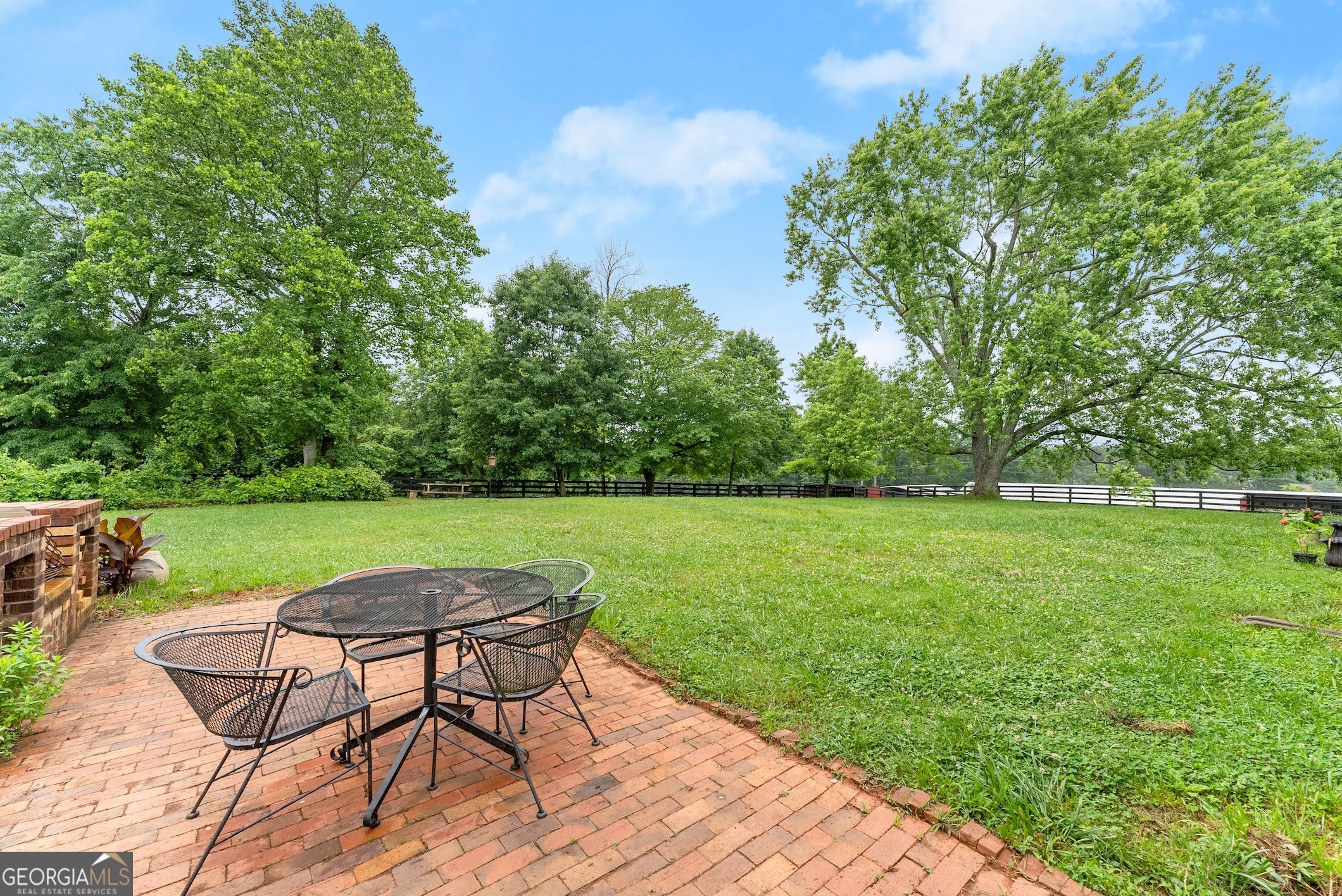 7215 Kelly Bridge Road Dawsonville, GA 30534 - Photo 48 of 87 a view of a lake with table and chairs under an umbrella