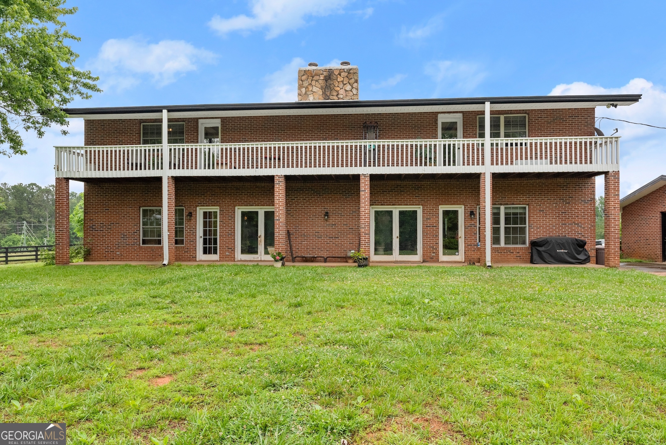 7215 Kelly Bridge Road Dawsonville, GA 30534 - Photo 52 of 87 a front view of a house with a garden