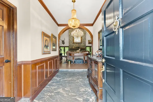 a living room with furniture a rug and a large window