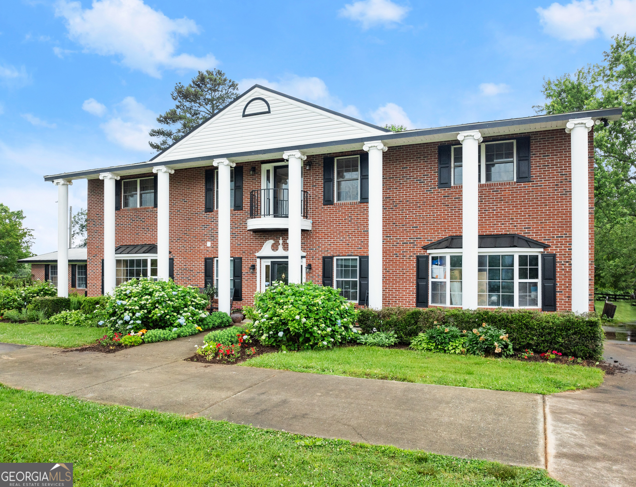 7215 Kelly Bridge Road Dawsonville, GA 30534 - Photo 86 of 87 a front view of a house with a yard and trees