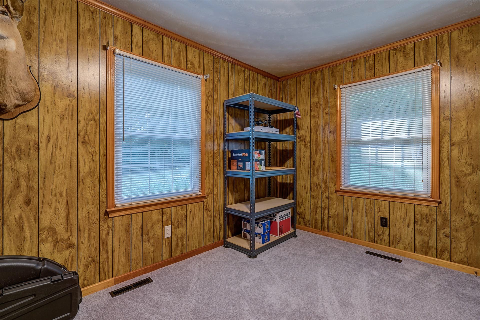 5960 Goodview Road Goodview, VA 24095 - Photo 17 of 38 a view of an empty room with a window and storage