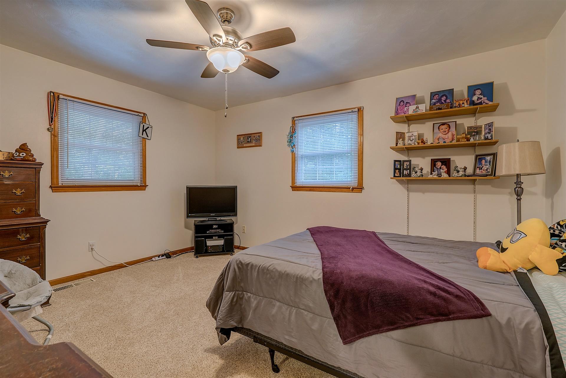 5960 Goodview Road Goodview, VA 24095 - Photo 20 of 38 a bedroom with a bed and dresser
