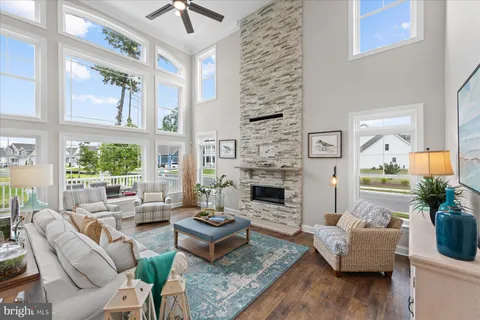 a living room with furniture fireplace and a large window