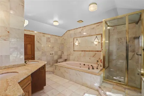 a view of an empty room with window and hardwood floor