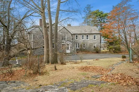 a view of a yard with wooden fence