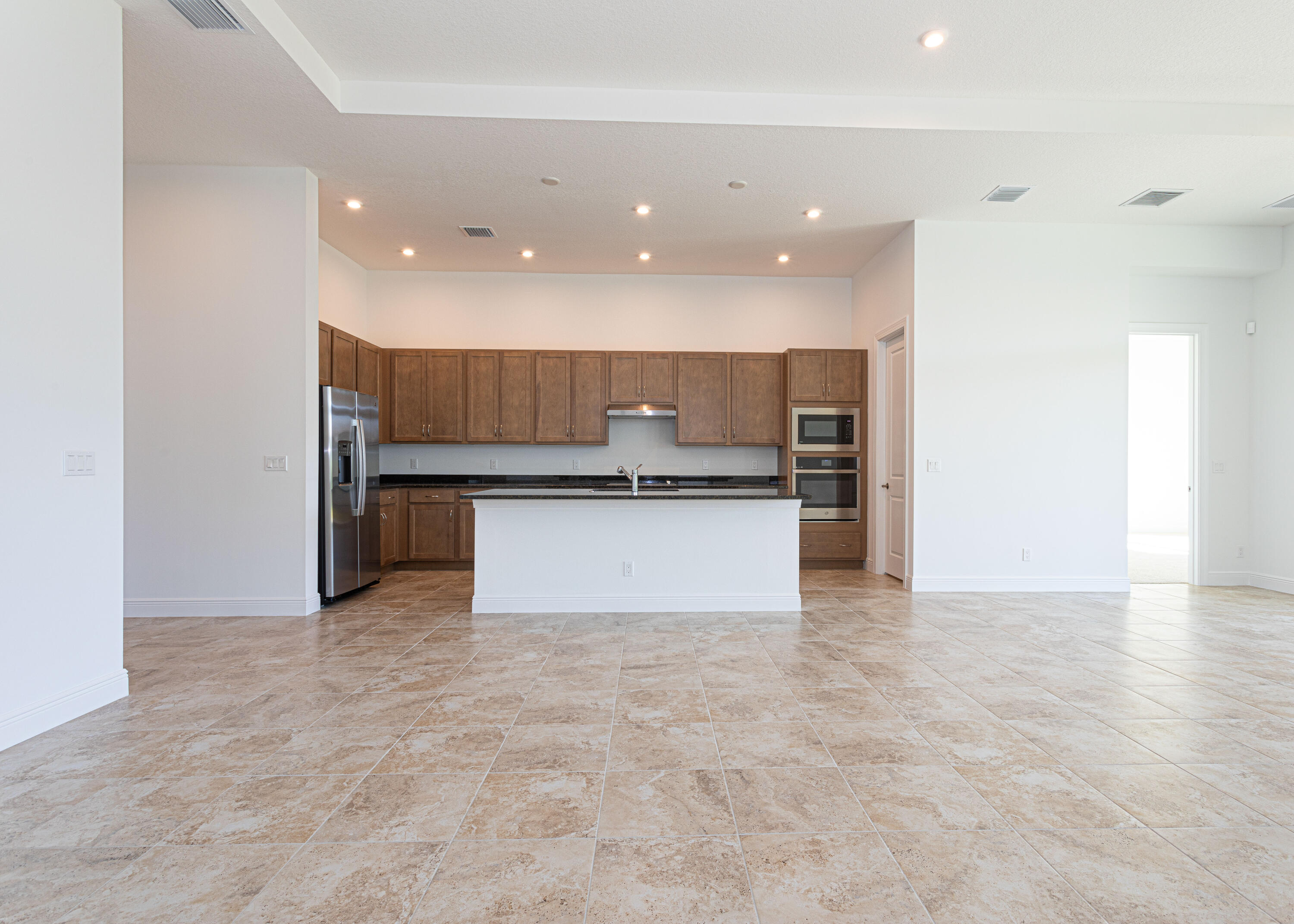 9155 Southwest Esule Way Port St. Lucie, FL 34987 - Photo 12 of 49 a view of kitchen with kitchen island a sink stainless steel appliances and cabinets