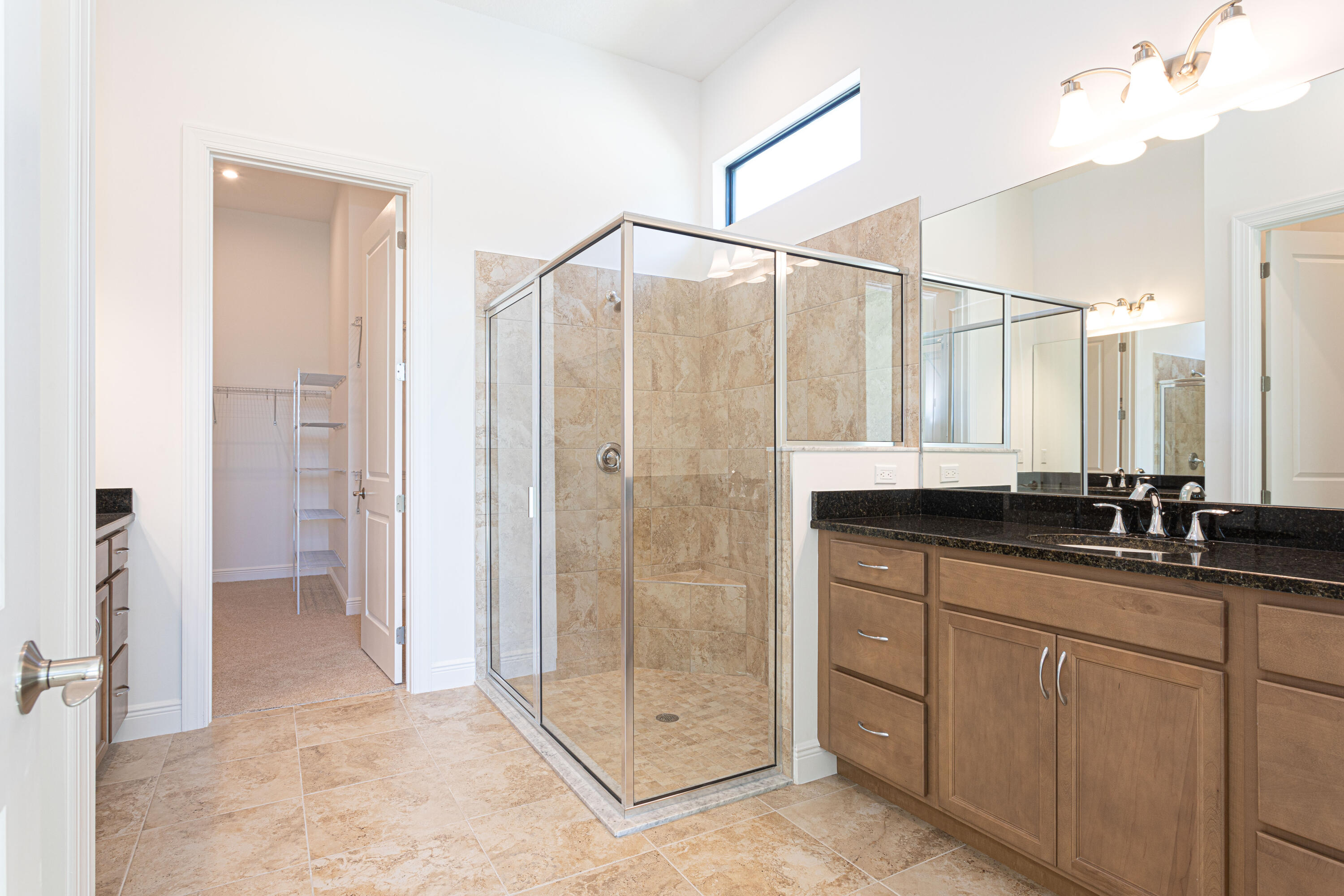 9155 Southwest Esule Way Port St. Lucie, FL 34987 - Photo 18 of 49 a bathroom with a double vanity sink and mirror