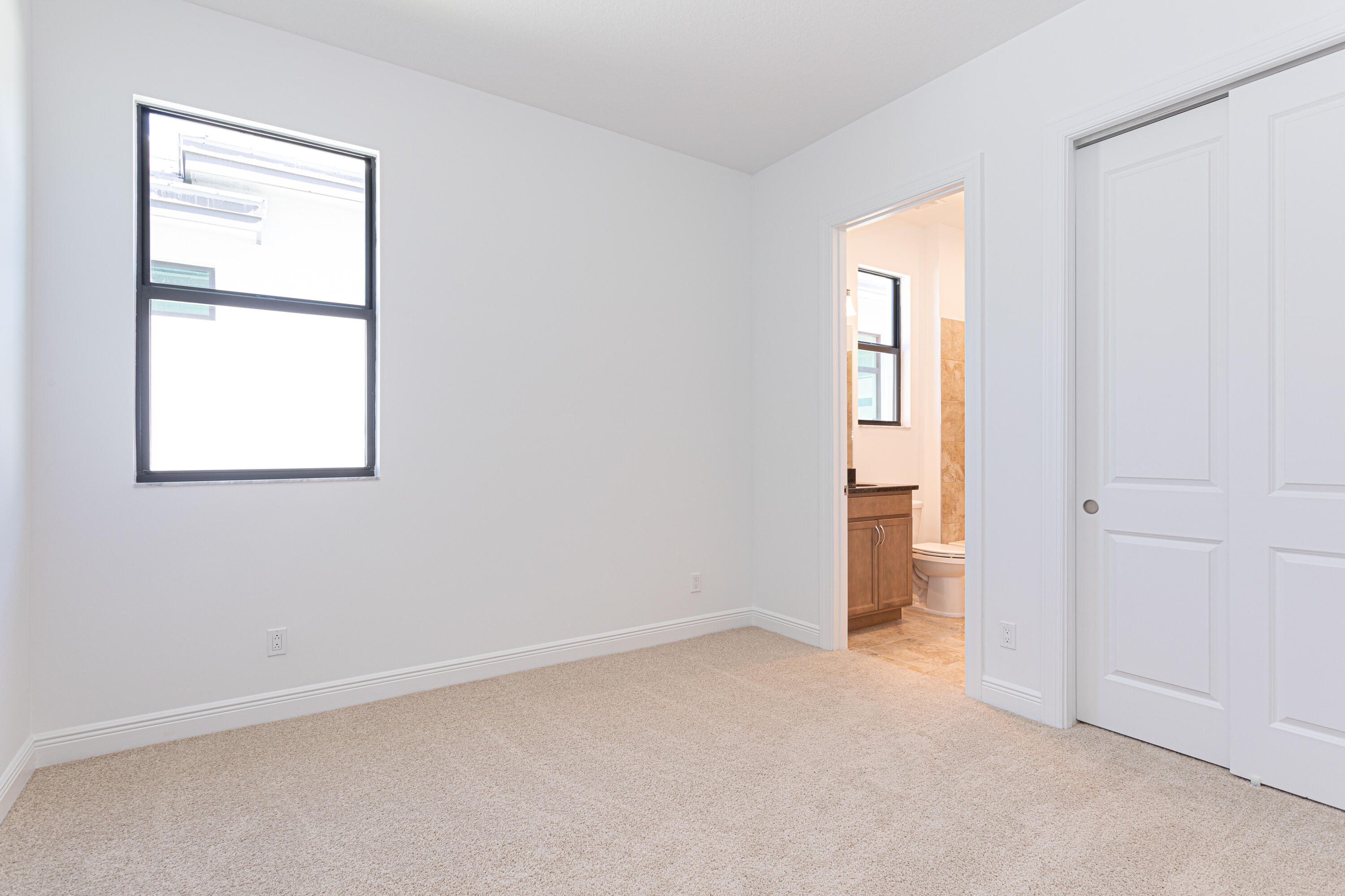 9155 Southwest Esule Way Port St. Lucie, FL 34987 - Photo 25 of 49 an empty room with windows and closet
