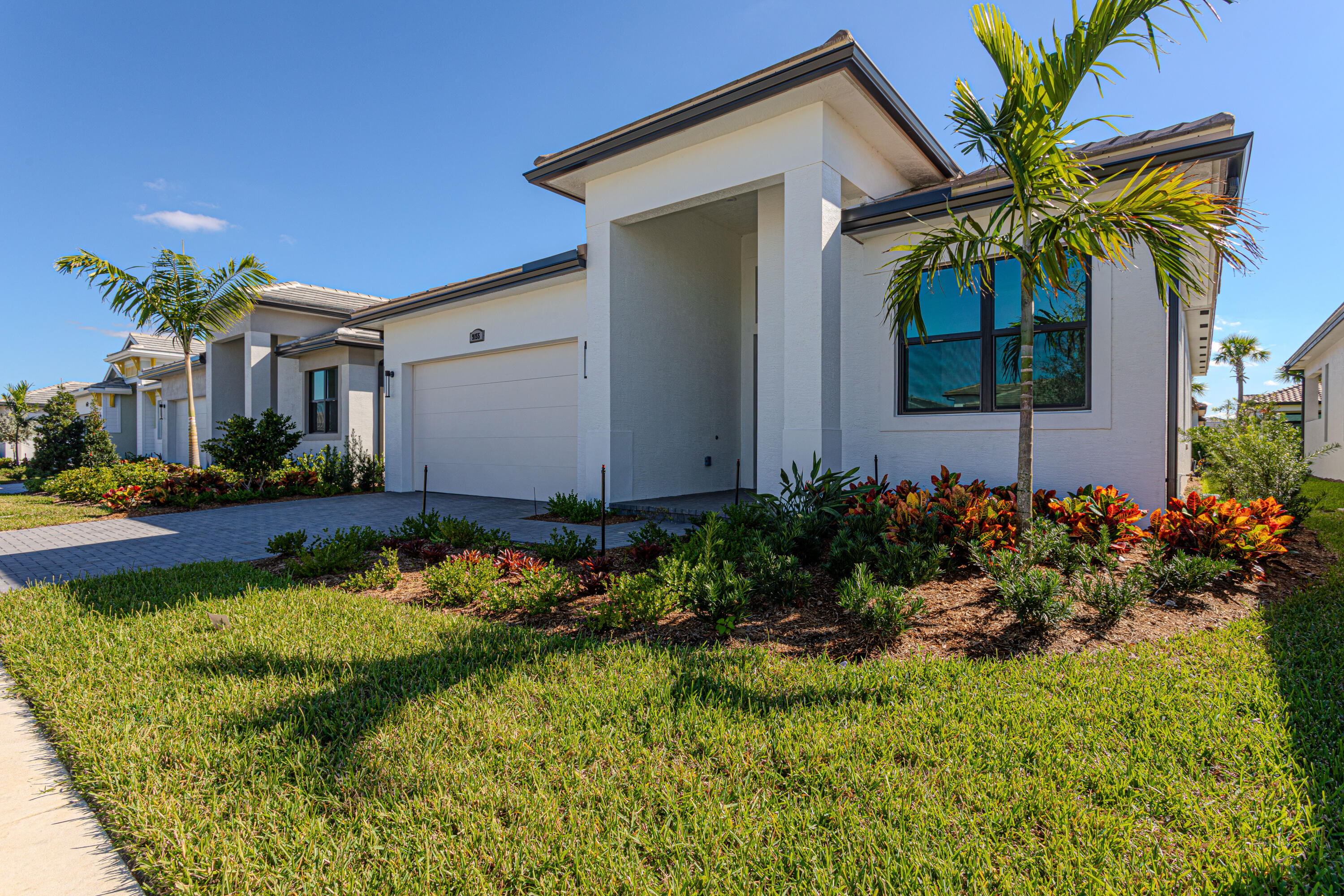 9155 Southwest Esule Way Port St. Lucie, FL 34987 - Photo 3 of 49 a front view of a house with a yard