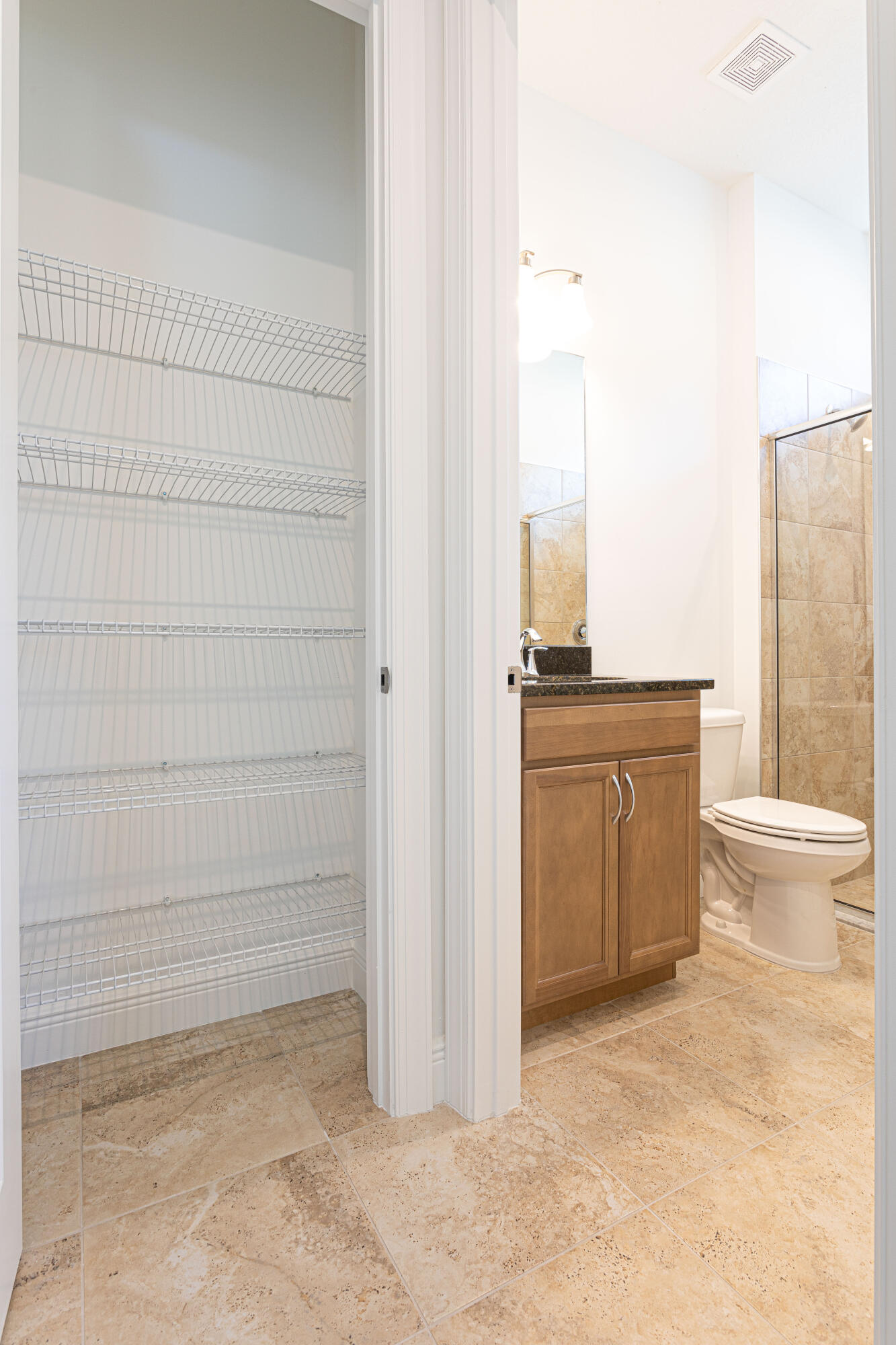 9155 Southwest Esule Way Port St. Lucie, FL 34987 - Photo 32 of 49 a bathroom with a sink a toilet and shower