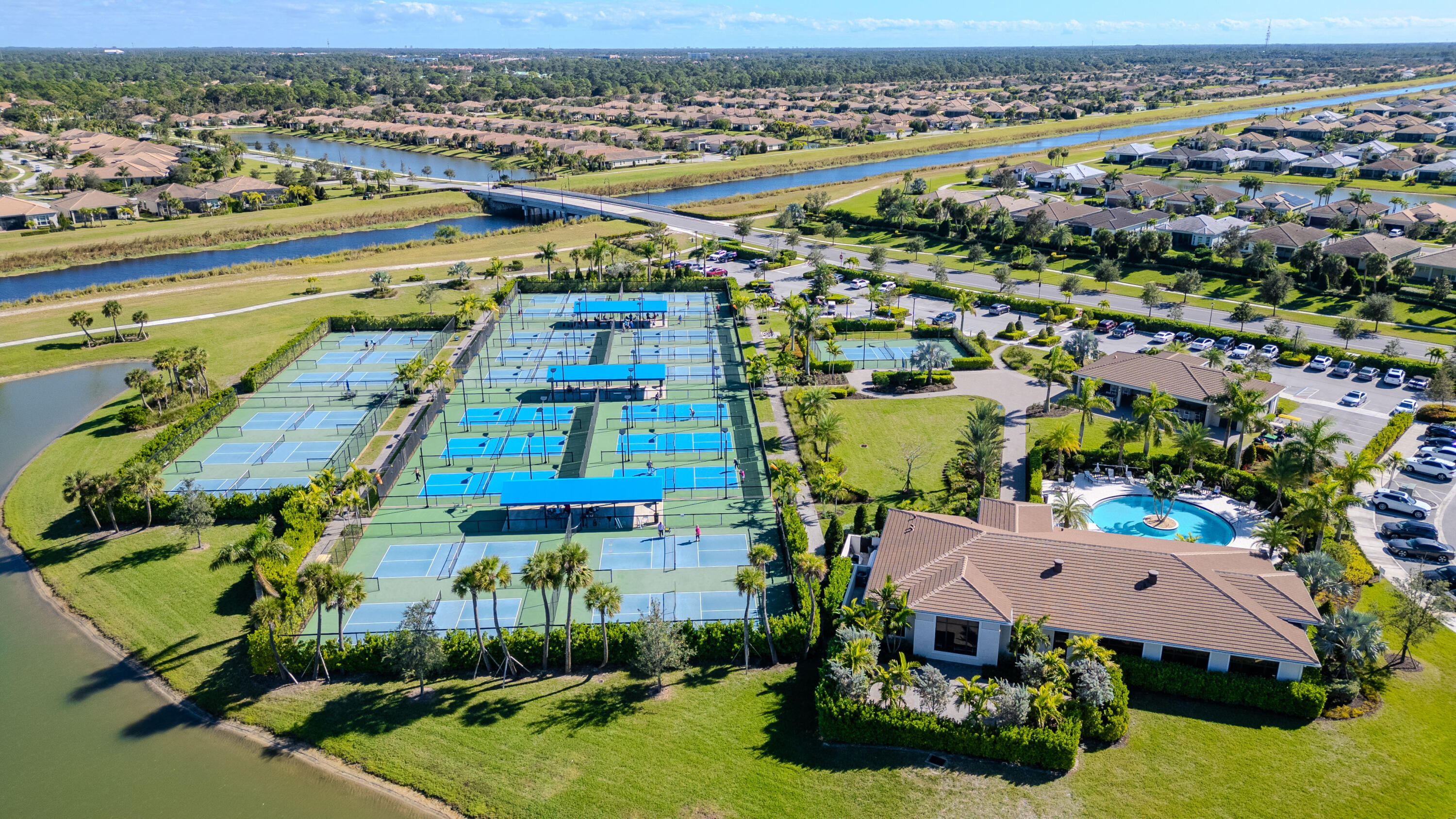 9155 Southwest Esule Way Port St. Lucie, FL 34987 - Photo 45 of 49 an aerial view of residential houses with outdoor space and parking