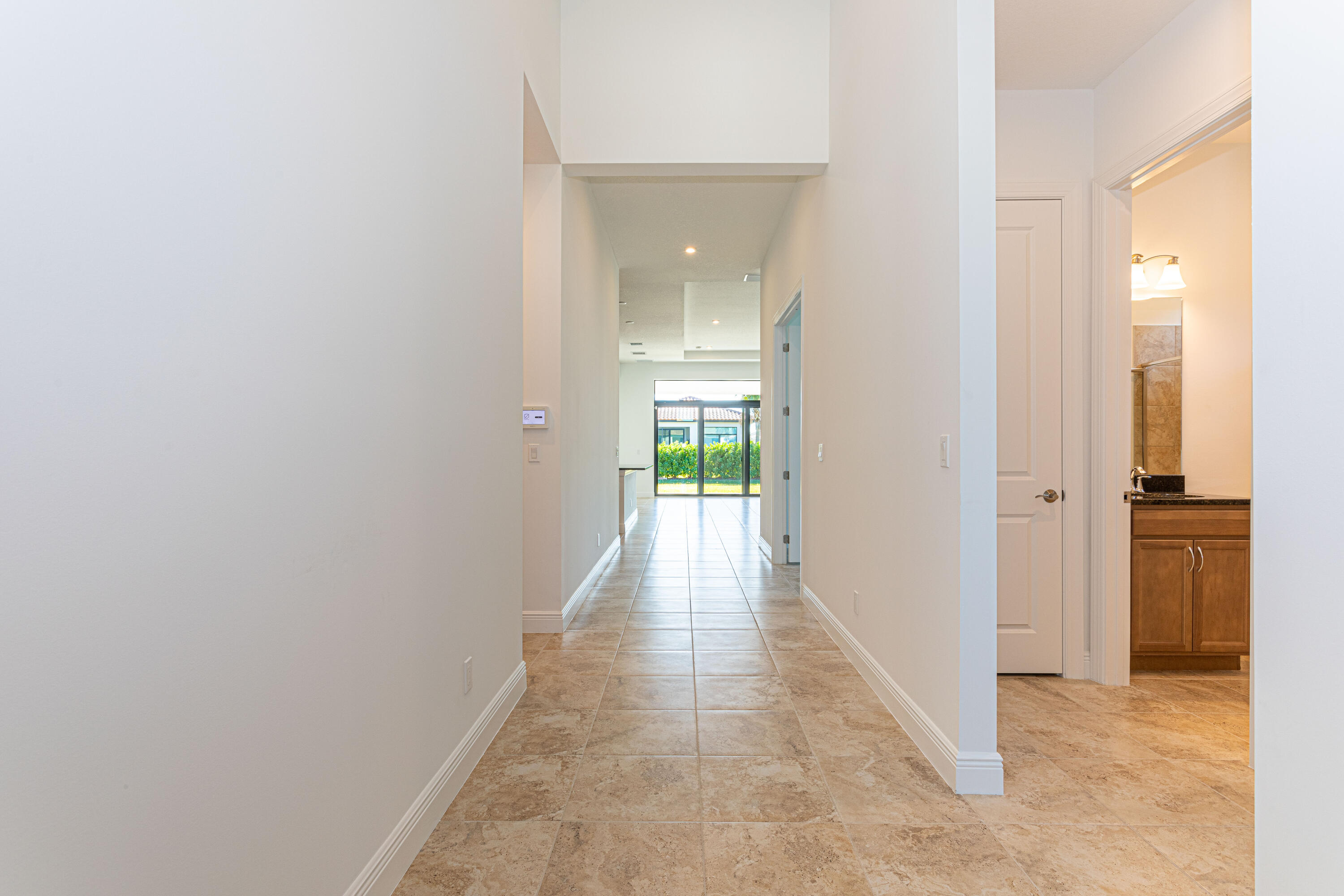 9155 Southwest Esule Way Port St. Lucie, FL 34987 - Photo 6 of 49 a view of a hallway with wooden floor