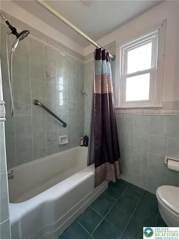 a bathroom with a sink a toilet and a bathtub