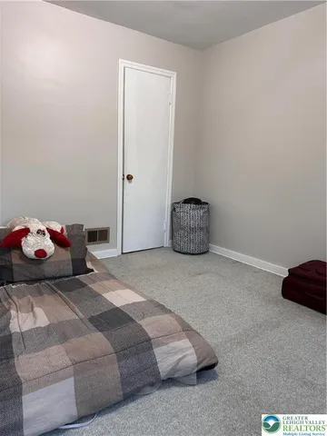 a bedroom with a bed and a chair