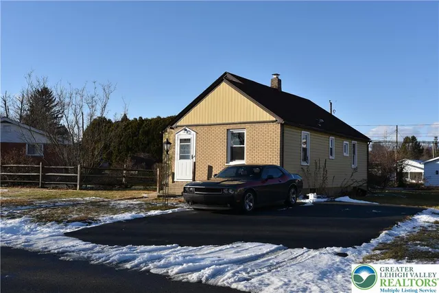 a view of a backyard with large trees