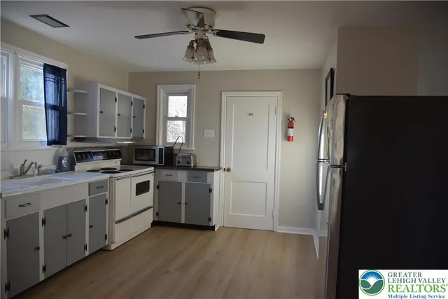 a kitchen with a refrigerator stove and sink