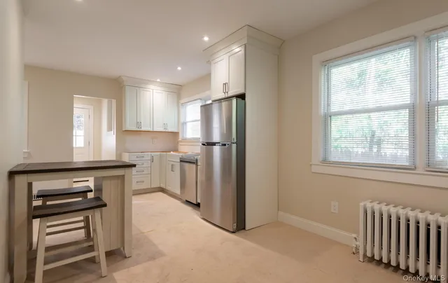 a kitchen with a refrigerator a stove and a window