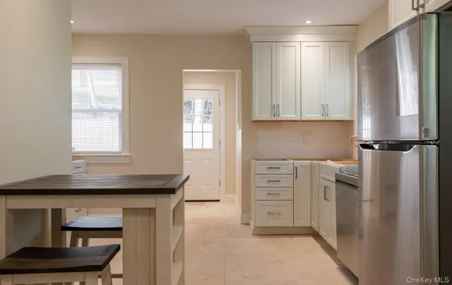 a kitchen with a refrigerator and cabinets