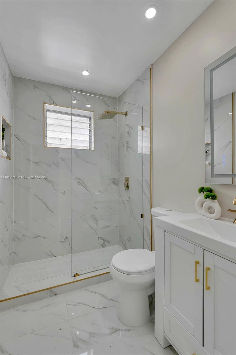1852 Southwest 22nd Terrace, Unit 1 Miami, FL 33145 - Photo 14 of 24 a bathroom with a shower a toilet and a shower