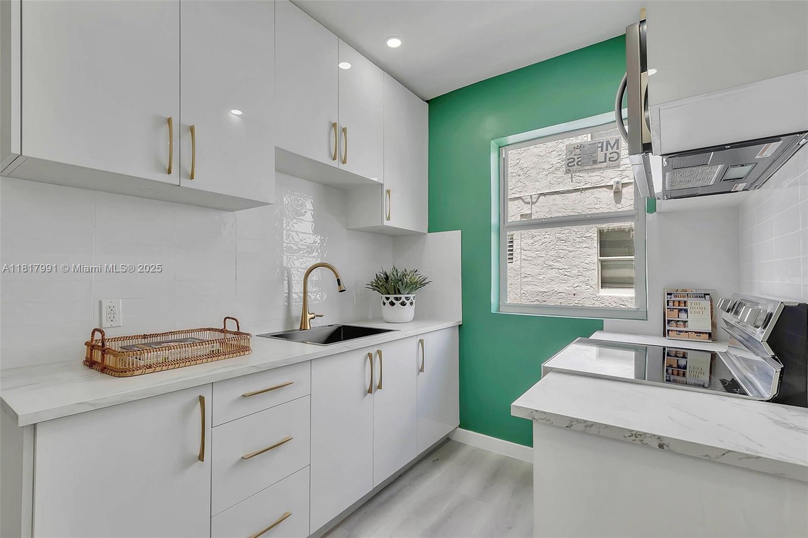 1852 Southwest 22nd Terrace, Unit 1 Miami, FL 33145 - Photo 8 of 24 a kitchen with a sink cabinets and a window