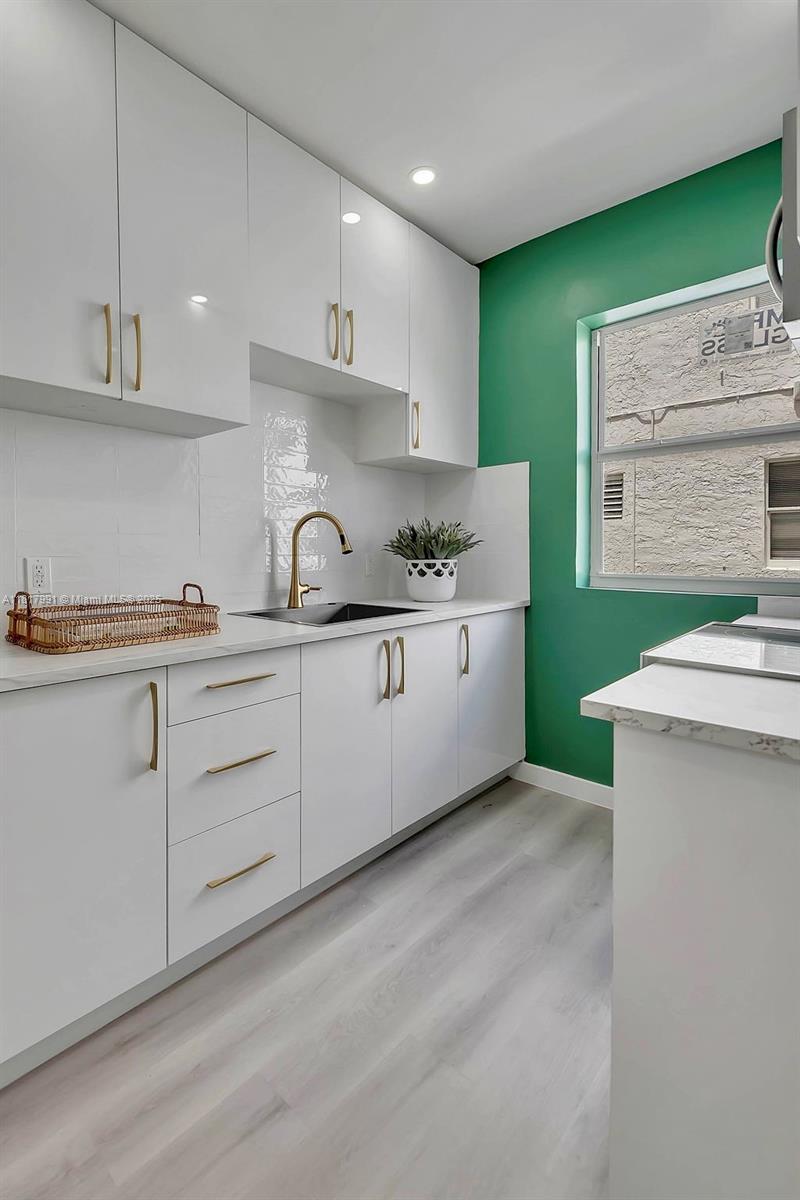 1852 Southwest 22nd Terrace, Unit 1 Miami, FL 33145 - Photo 9 of 24 a kitchen with a sink cabinets and appliances