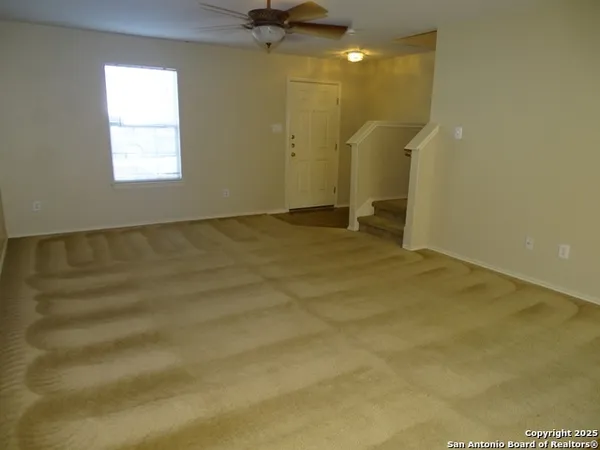 a view of empty room with a kitchen
