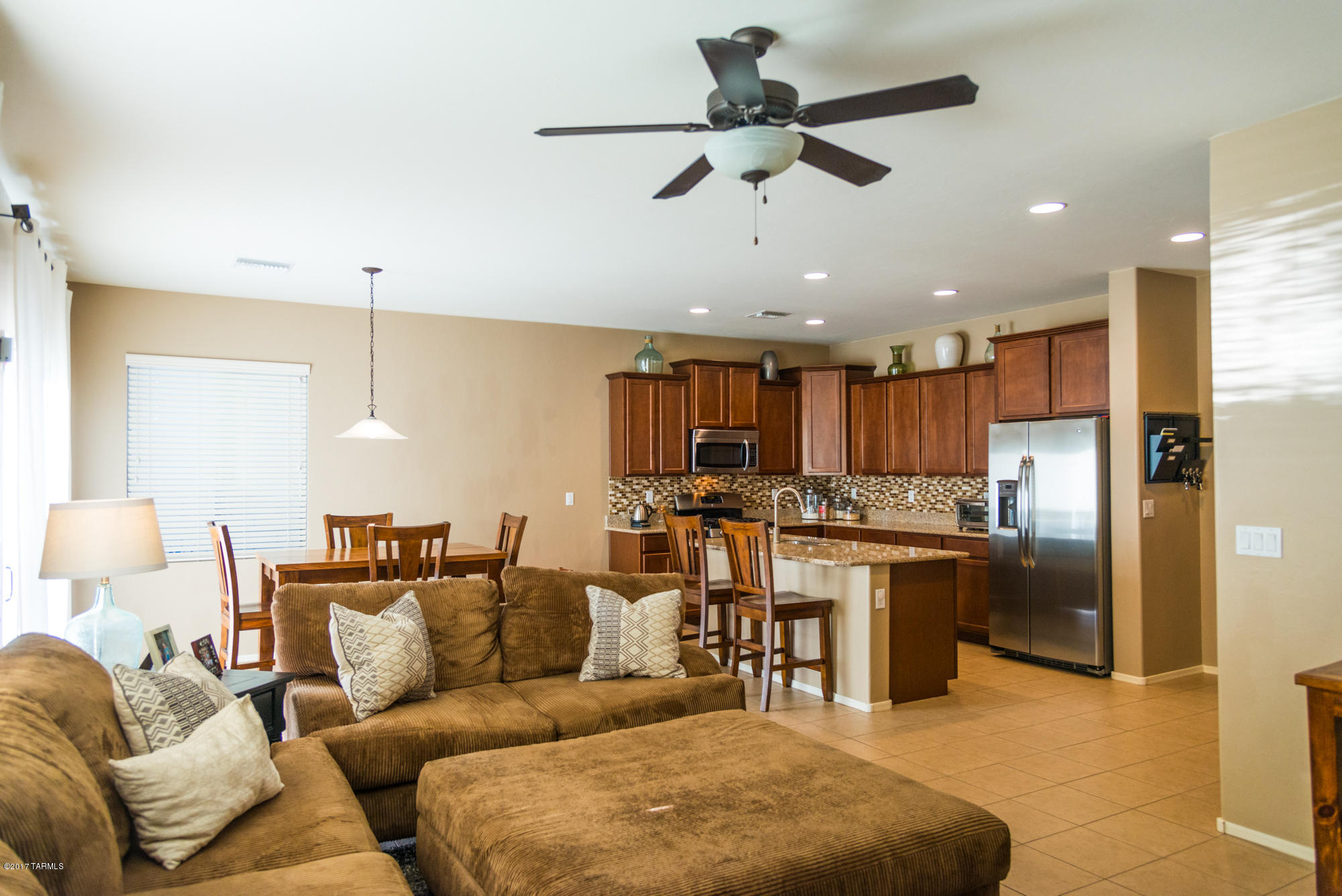 4405 West Crystal Ranch Place Marana, AZ 85658 - Photo 1 of 44 a living room with stainless steel appliances kitchen island granite countertop furniture and a view of kitchen