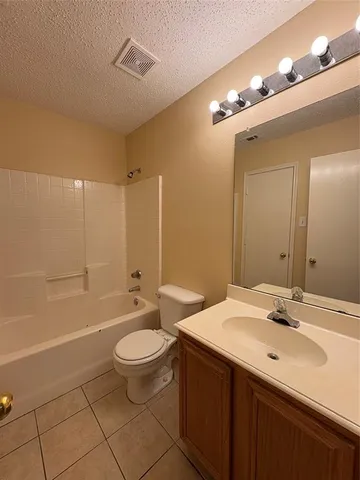 a bathroom with a double vanity sink toilet mirror and shower