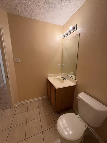 a bathroom with a sink vanity mirror and toilet