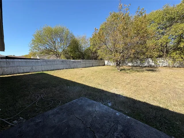 a white house that has a tree in front of it