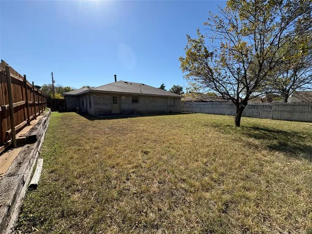 a white house with a large tree in front of it