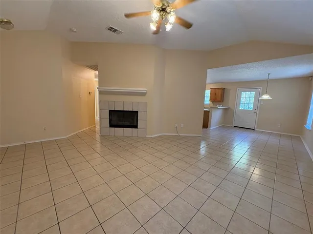 a view of an empty room with glass door
