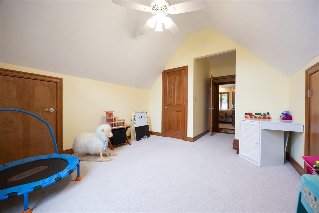 70 Azalea Way Hanson, MA 02341 - Photo 38 of 42 a bedroom with furniture and a chandelier