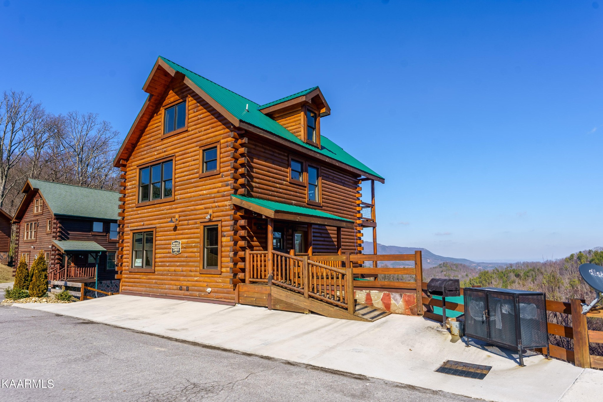 a backyard of a house with barbeque oven and outdoor seating
