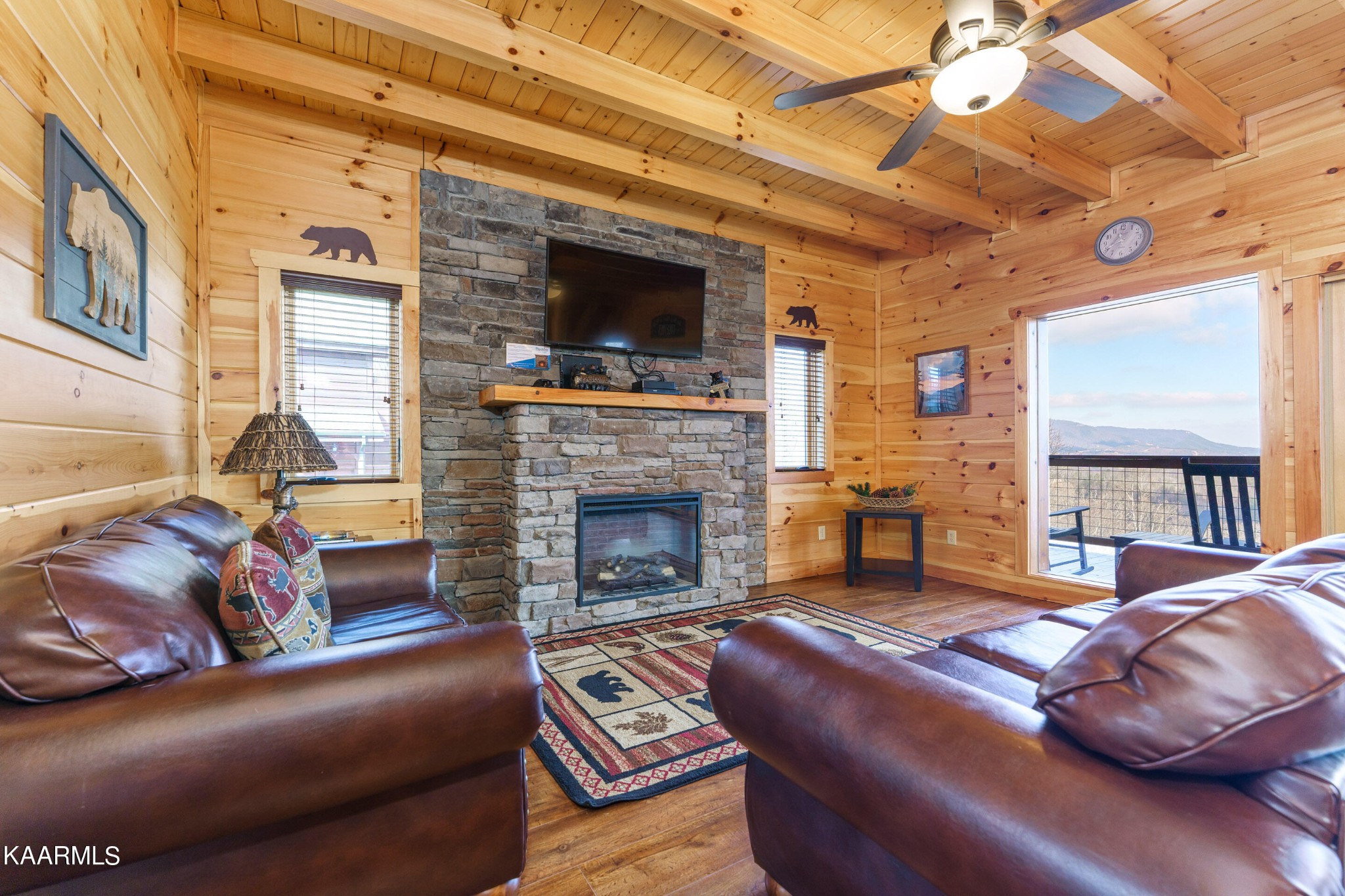 2805 White Oak Ridge Lane Sevierville, TN 37862 - Photo 2 of 25 a living room with furniture a flat screen tv and a fireplace