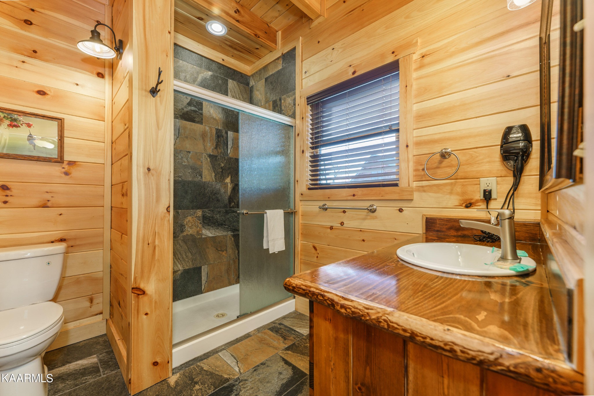 2805 White Oak Ridge Lane Sevierville, TN 37862 - Photo 7 of 25 a bathroom with a granite countertop sink a toilet and shower