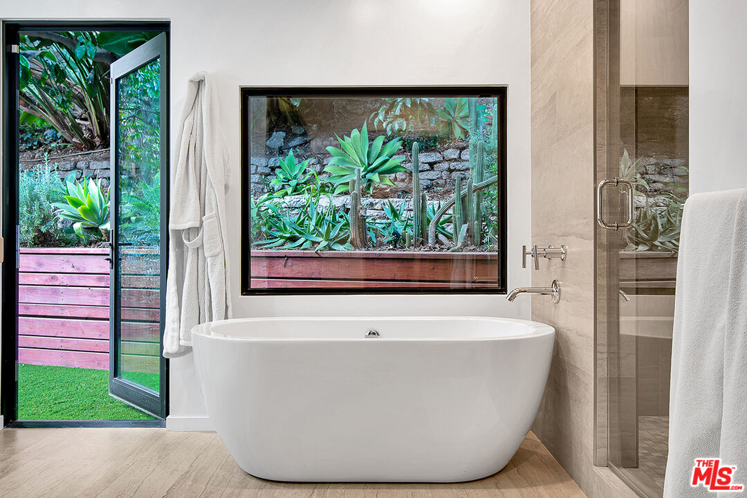 1633 Queens Road Los Angeles, CA 90069 - Photo 12 of 16 a white bath tub sitting in front of a window
