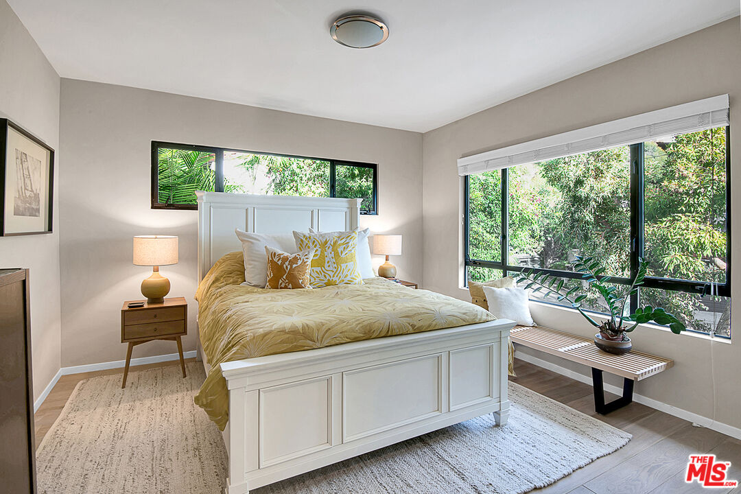 1633 Queens Road Los Angeles, CA 90069 - Photo 13 of 16 a bed sitting in a bedroom next to a window