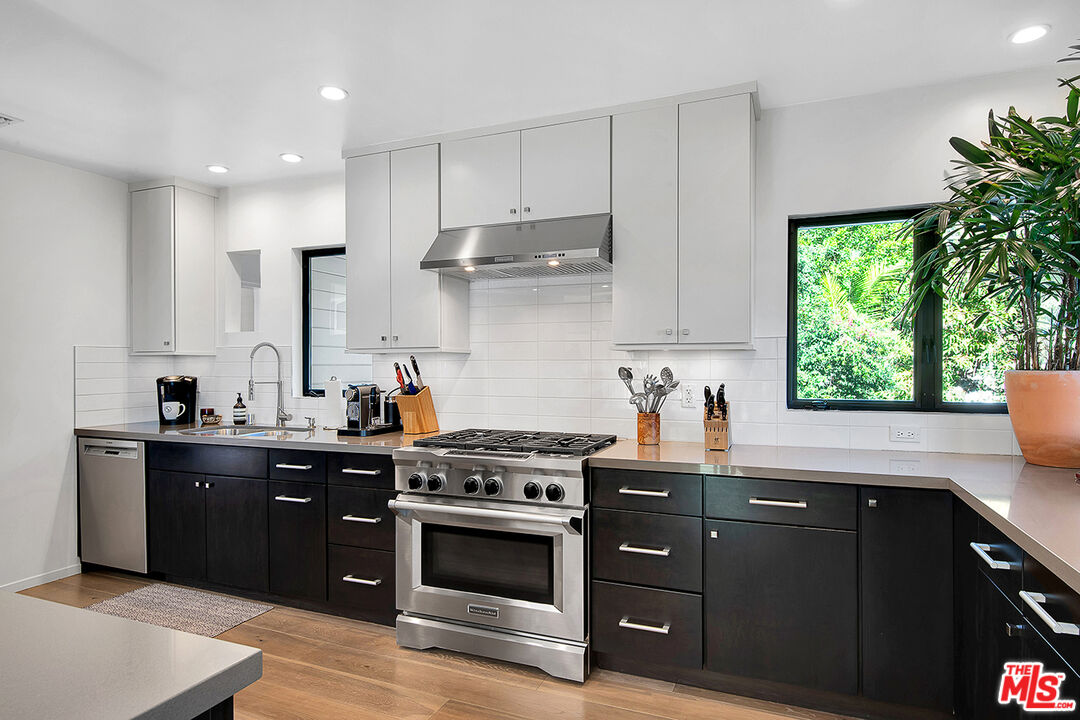 1633 Queens Road Los Angeles, CA 90069 - Photo 6 of 16 a kitchen with stainless steel appliances a sink cabinets and a window