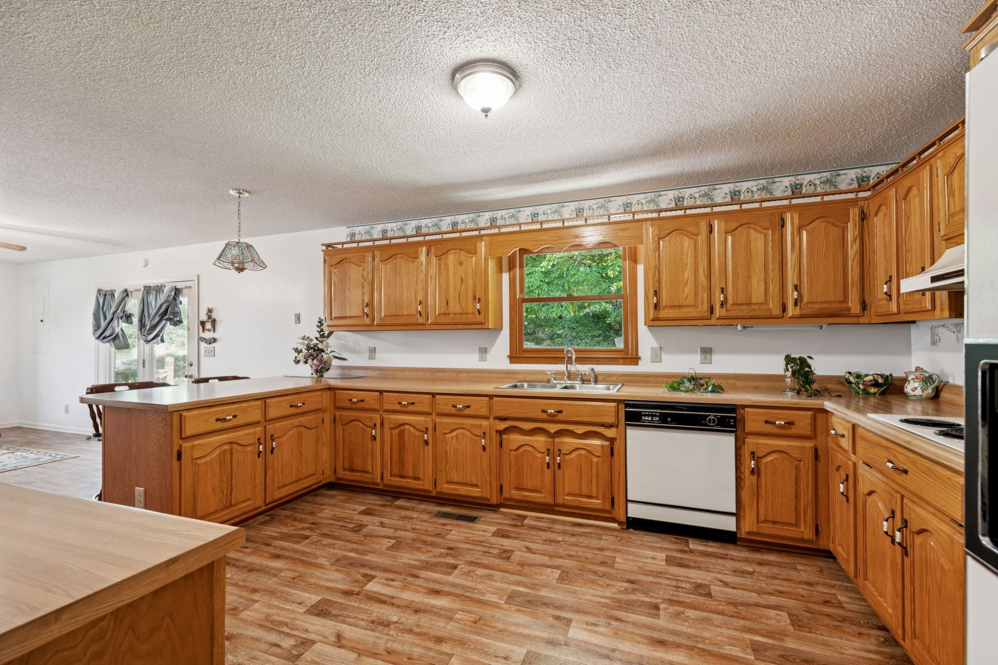 8663 Dog Branch Road Mount Pleasant, TN 38474 - Photo 12 of 42 a kitchen with stainless steel appliances granite countertop wooden cabinets a stove a sink and a microwave