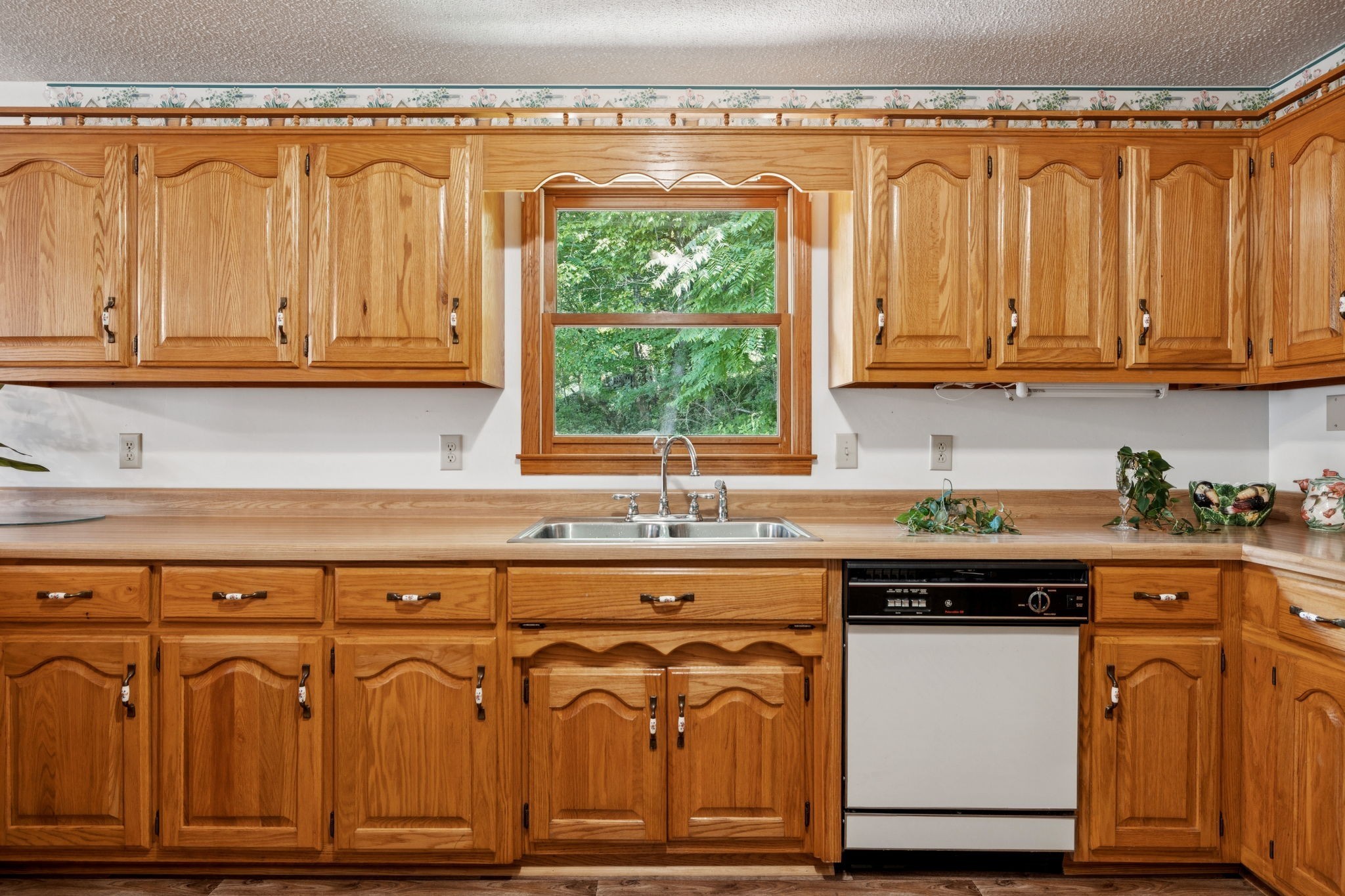 8663 Dog Branch Road Mount Pleasant, TN 38474 - Photo 15 of 42 a kitchen with granite countertop a stove and white cabinets