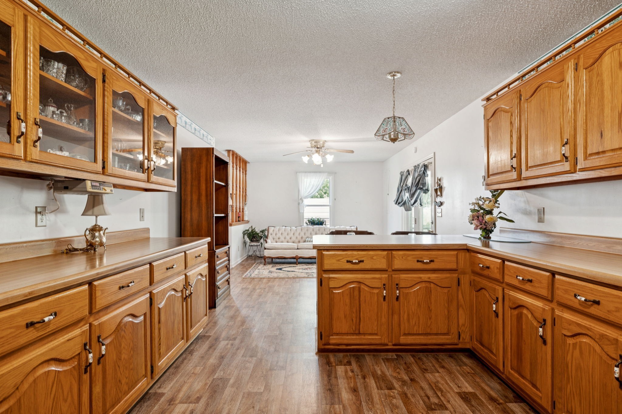 8663 Dog Branch Road Mount Pleasant, TN 38474 - Photo 16 of 42 a large kitchen with stainless steel appliances granite countertop a stove a sink dishwasher and white cabinets with wooden floor
