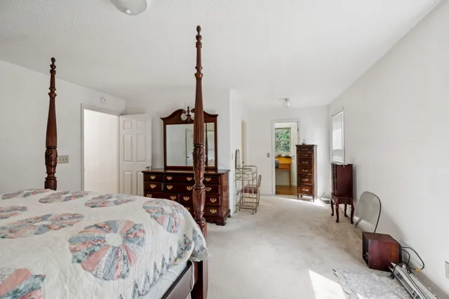 a bedroom with a bed and dresser