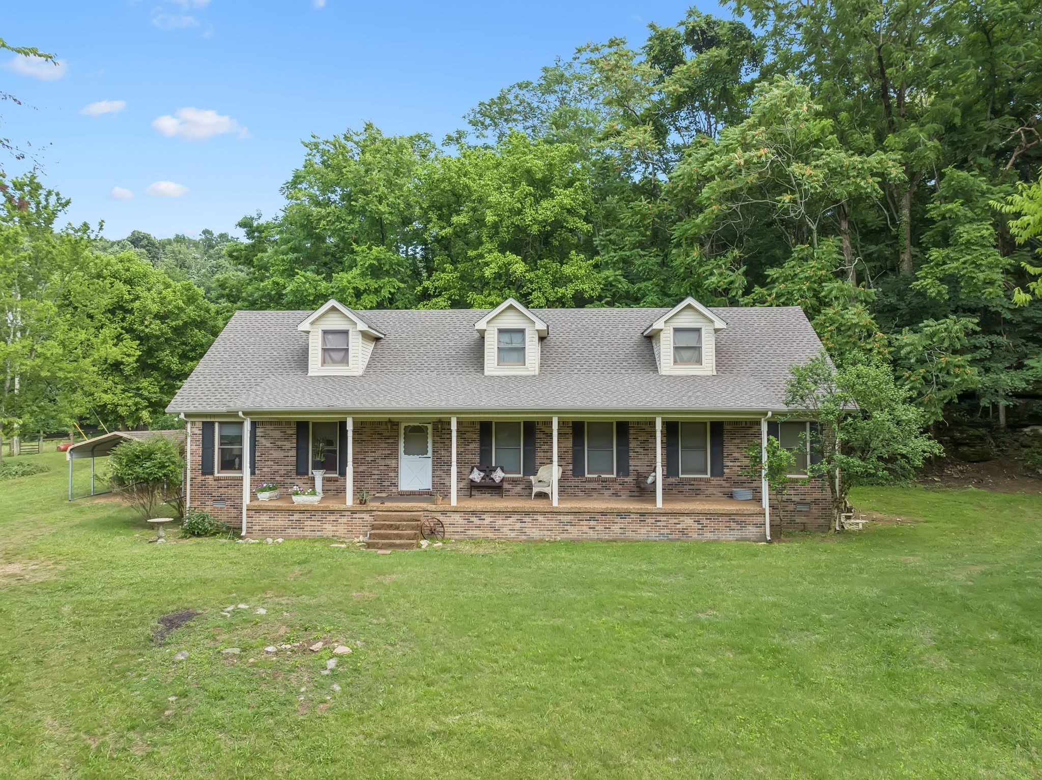 8663 Dog Branch Road Mount Pleasant, TN 38474 - Photo 37 of 42 a front view of a house with a yard table and chairs