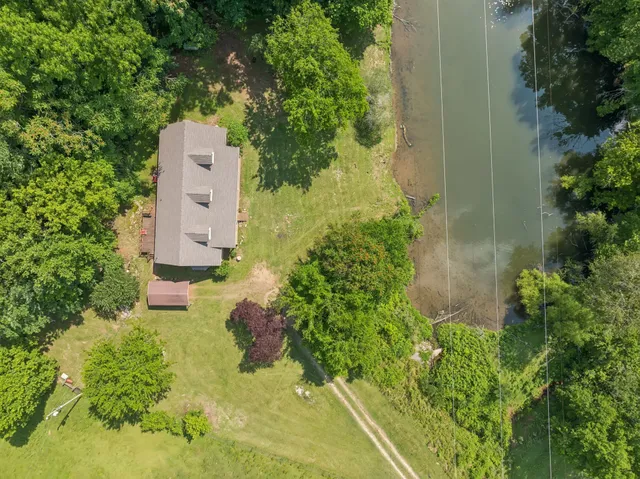 an aerial view of a house with a yard