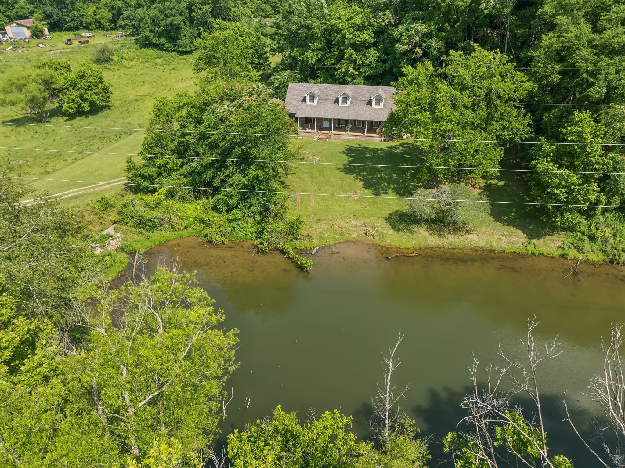 8663 Dog Branch Road Mount Pleasant, TN 38474 - Photo 42 of 42 a picture of a lake with a house in the background