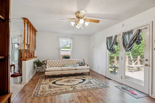 a spacious bedroom with a bed a chandelier and large window